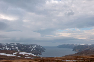 Scenic view of sea and mountains against sky
