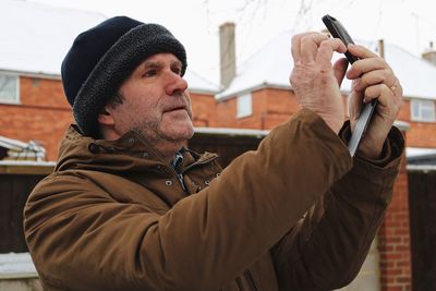 Close-up of man using mobile phone