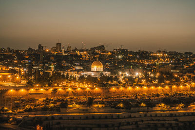 High angle view of city lit up at night