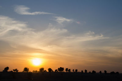 Silhouette landscape against sky during sunset