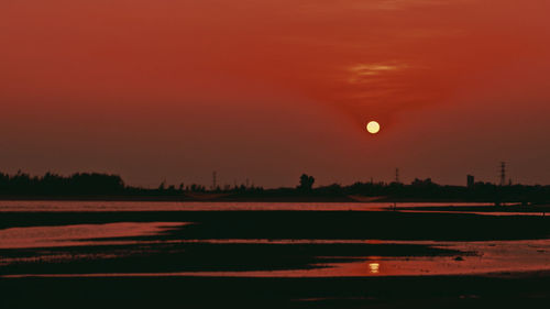 Scenic view of land against sky during sunset