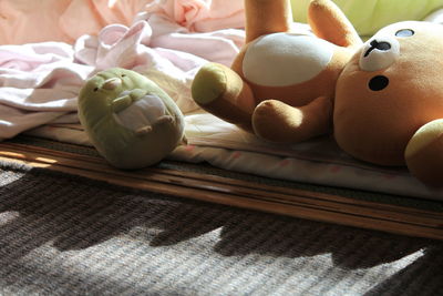 High angle view of stuffed toys on bed