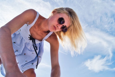 Midsection of woman with dog against sky