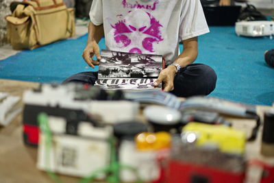 Midsection of man working and reading in denpasar, bali, indonesia.