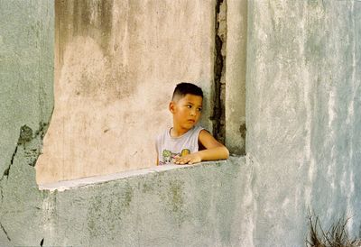 Portrait of boy sitting outdoors