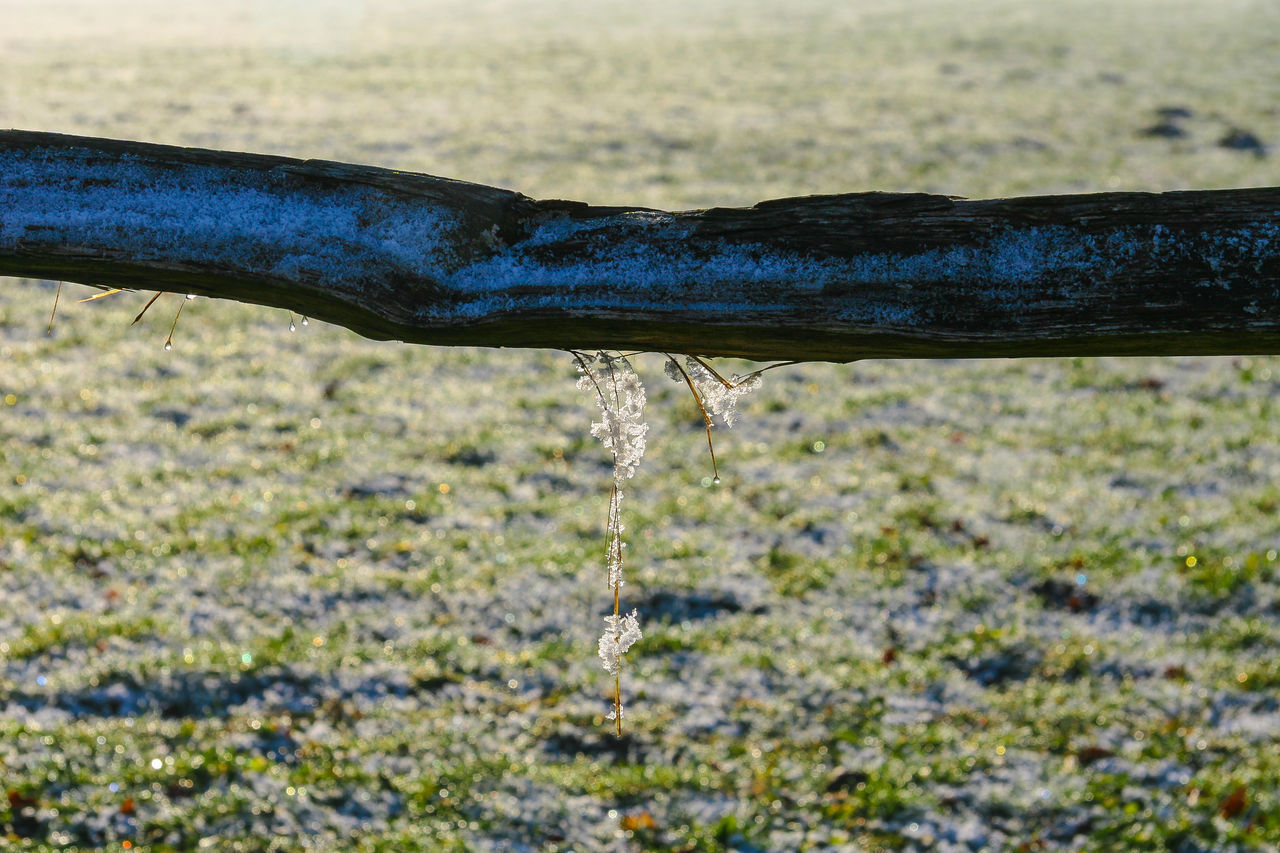 CLOSE-UP OF WATER DROPS FALLING FROM PIPE ON LAND