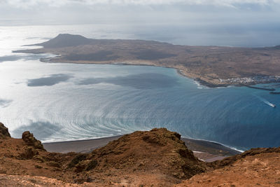 Scenic view of sea and mountains against sky