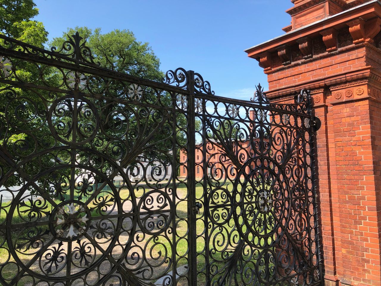 VIEW OF METAL GATE AGAINST BUILDING