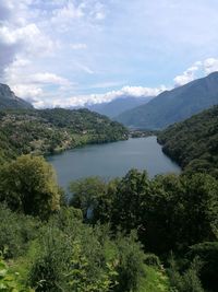 Scenic view of lake and mountains against sky