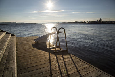 Diving platform on boardwalk by lake