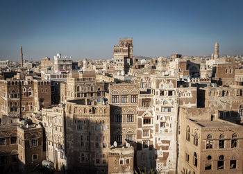 View of buildings in city against clear sky