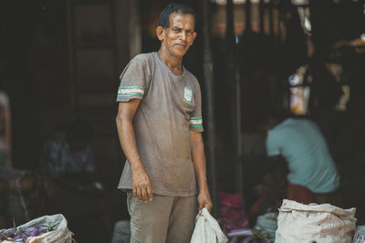 Portrait of smiling man standing outdoors