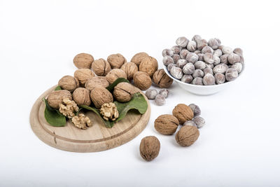 High angle view of roasted coffee beans against white background