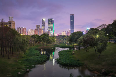 Canal amidst buildings in city against sky