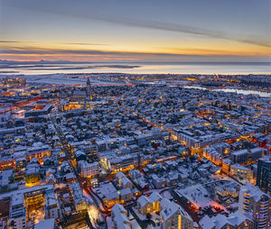 Snowy houses during sunset in coastal city