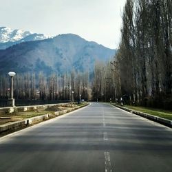 Empty road leading towards mountains