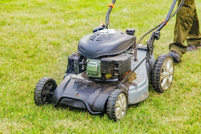 Low section of person using lawn mower