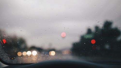 Close-up of raindrops on car windshield