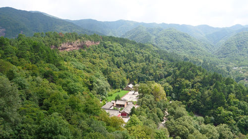 High angle view of trees and houses against mountains