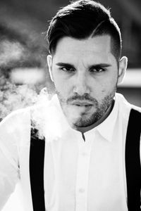 Close-up portrait of man smoking cigarette