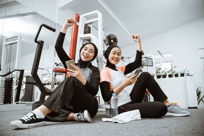 Portrait of smiling friends exercising in gym