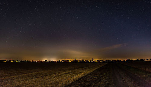 Scenic view of field against sky at night