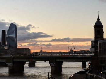 View of bridge over river against cloudy sky