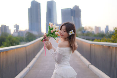 Young woman holding bouquet