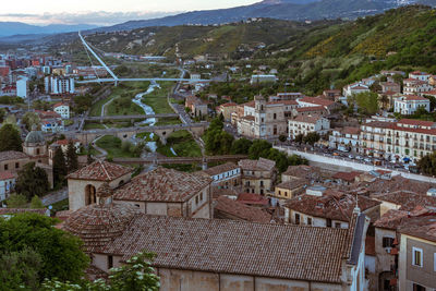 High angle view of buildings in town against sky during sunset