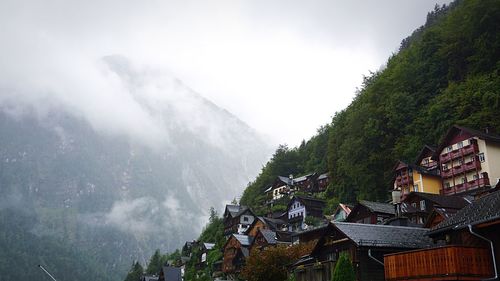 Panoramic view of houses and mountains against sky