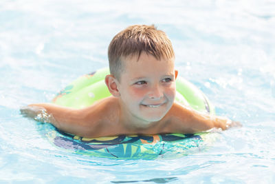 Portrait of boy swimming in pool