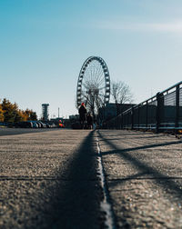 Low angle view of ferris wheel against sky