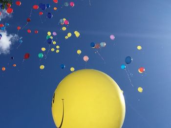 Close-up of balloons against blue sky