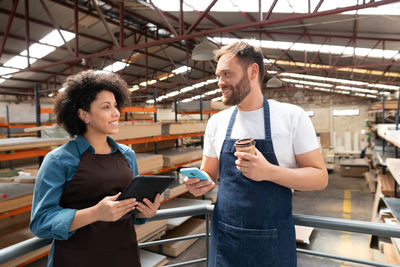 Smiling workers talking at workshop