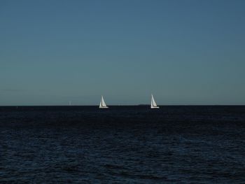 Sailboat sailing on sea against sky