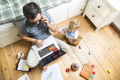 Father with his little son working from home