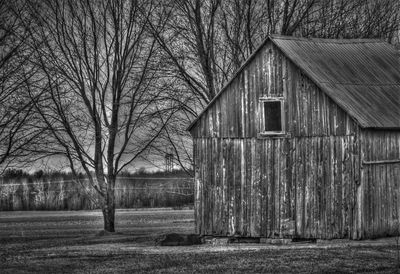 View of old barn on field