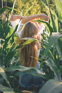 Portrait of woman with plants in sunlight