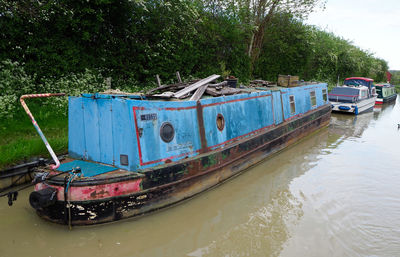 Abandoned boat moored on shore