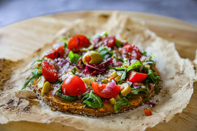 High angle view of raw vegan pizza in plate on table