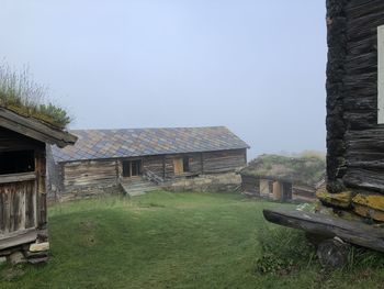 House on field against clear sky