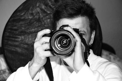 Close-up of man photographing with camera