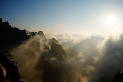 Scenic view of mountains against cloudy sky