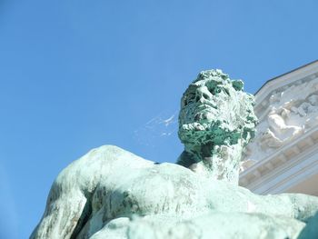 Low angle view of statue against clear blue sky