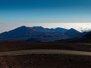 Scenic view of mountains against clear blue sky