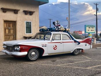 Vintage car on street against buildings