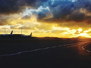 Scenic view of dramatic sky over silhouette mountains