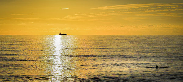 Scenic view of sea against orange sky