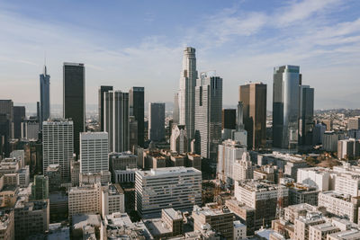 Aerial view of modern buildings in city against sky