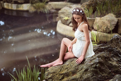 Woman sitting on rock